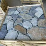 Collection of irregular flagstone pavers in various shapes and colors