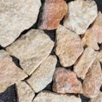Variety of irregular flagstone pavers featuring earthy tones and textures