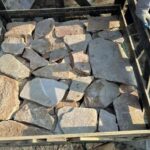 A collection of irregular flagstone pavers in various shapes and colors