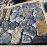 Collection of irregular flagstone pavers in various natural colors