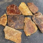 Diverse assortment of irregular flagstone pavers in rich colors