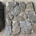 Collection of irregular flagstone pavers in various colors and textures