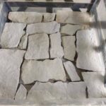 A display of irregular flagstone pavers in natural colors
