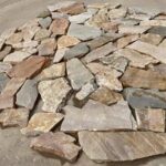 Collection of irregular flagstone pavers in varying colors and textures