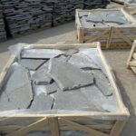 A variety of irregular flagstone pavers in different shapes and sizes for outdoor landscaping.